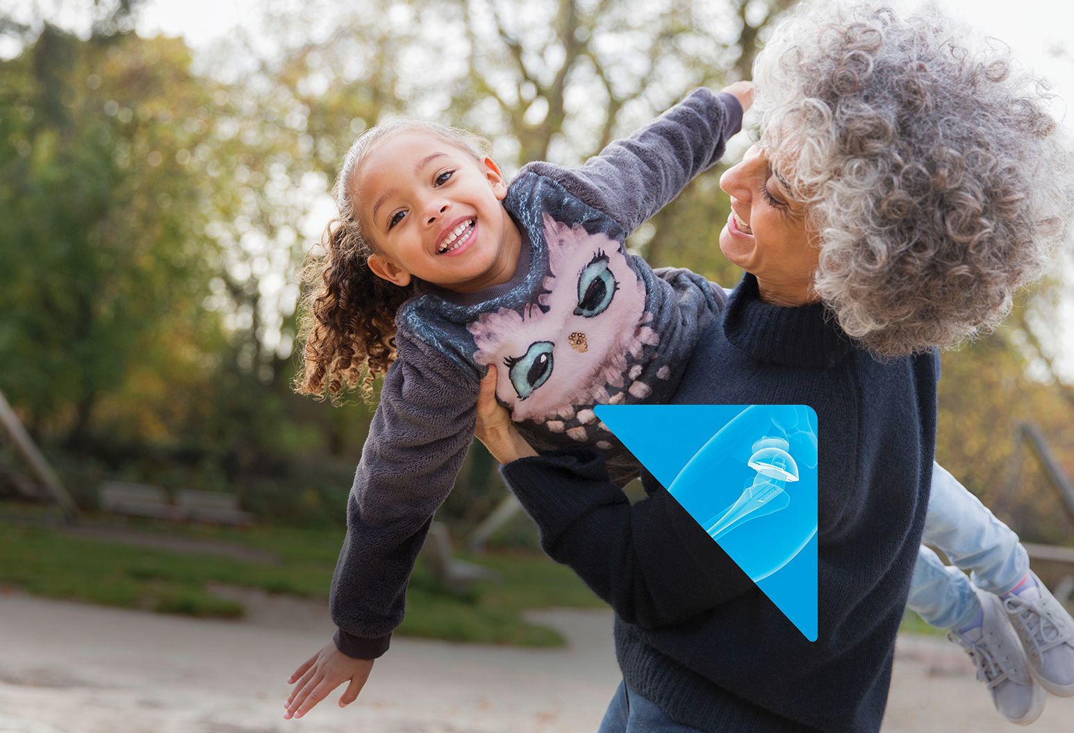 Grandma holding granddaughter in a flying pose.